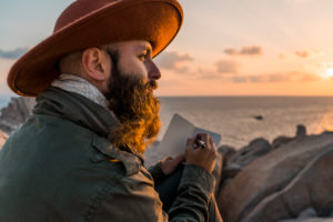 Italy, Sardinia, back view of man wearing hat looking at view - a Royalty  Free Stock Photo from Photocase