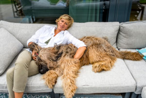 Woman relaxing with dog on terrace at home Woman relaxing with dog on terrace at home