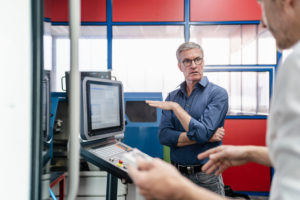Businessmen in factory, having a meeting, discussing solutions Businessmen in factory, having a meeting, discussing solutions