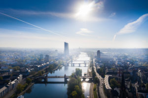 Germany, Hesse, Frankfurt, Helicopter view of sun shining over river Main and surrounding city buildings Germany, Hesse, Frankfurt, Helicopter view of sun shining over river Main and surrounding city buildings