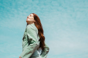 Portrait of redheaded young woman with eyes closed against sky Portrait of redheaded young woman with eyes closed against sky