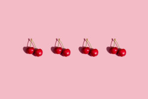 Row of fresh cherries on pink background Row of fresh cherries on pink background