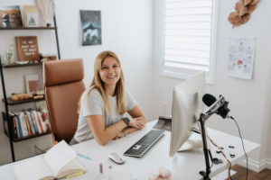 Smiling businesswoman using computer on desk at home Smiling businesswoman using computer on desk at home