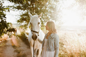 Woman with grey horse on a farm Woman with grey horse on a farm