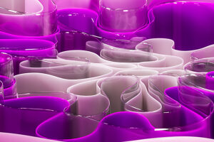 Abstract 3D design with pink and purple glass-like curves
