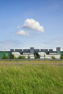 Exterior of data center with green facade under blue sky
