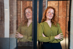 Confident businesswoman with red hair in modern office