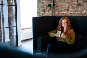 Woman working on smartphone in modern office space