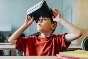 Primary student removing VR headset after lesson in classroom