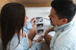 Expectant couple viewing ultrasound together at home