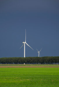 Wind turbines on a field under thunderstorm clouds in the Netherlands
