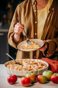 Eating homemade apple charlotte pie in a cozy country kitchen