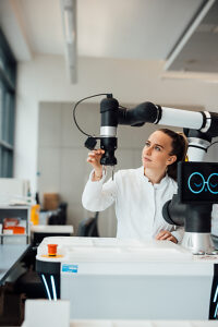 Scientist using robotic arm for research in modern medical laboratory