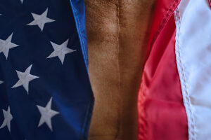 Close up of American flag and scarred chest representing patriotism