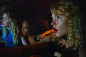 Friends experiencing fear together in a car during a creepy Halloween night