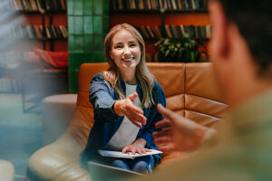 Business colleagues handshaking during meeting in office