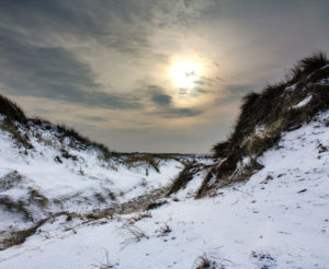 The North Sea, island, Sylt, snowy dunes in winter, sundown The North Sea, island, Sylt, snowy dunes in winter, sundown