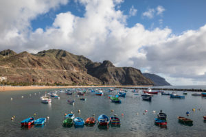 Colorful fishing boats in front of the Playa de las Teresitas beach and the Anaga Mountains, San Andres, Tenerife, Canary Islands, Spain Colorful fishing boats in front of the Playa de las Teresitas beach and the Anaga Mountains, San Andres, Tenerife, Canary Islands, Spain