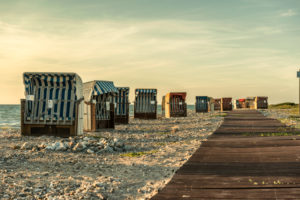 Wallnau, island of Fehmarn, Ostholstein, Schleswig-Holstein, Germany. Beach chairs on the beach of Wallnau in the evening light. Wallnau, island of Fehmarn, Ostholstein, Schleswig-Holstein, Germany. Beach chairs on the beach of Wallnau in the evening light.