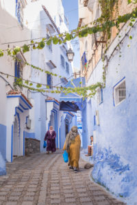 Pedestrians in a blue alley in Chefchaouen, Morocco, North Africa, Africa Pedestrians in a blue alley in Chefchaouen, Morocco, North Africa, Africa