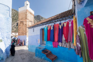 Mosque and sales stand in a blue alley of Chefchaouen, Morocco, North Africa, Africa Mosque and sales stand in a blue alley of Chefchaouen, Morocco, North Africa, Africa