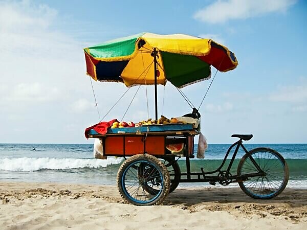 Bildagentur | mauritius images | Assortment of Fruit Rests on Bike Tray on  the Beach in Mancora, Peru