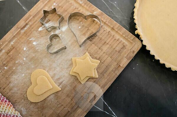 Happy birthday. Text from the salty crackers as printed English letters  that lie on a wooden chopping board. Message, lined with edible letters  Stock Photo - Alamy