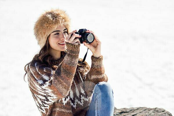 Premium Photo  Fashionable beautiful young scandinavian girl in stylish  winter warm clothes with coat and scarf walking in a winter forest in norway