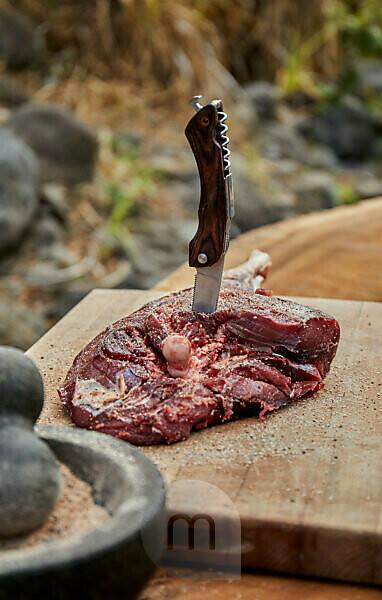 Barbecue Over Wood Fired Grill Near Stream by Cavan Images