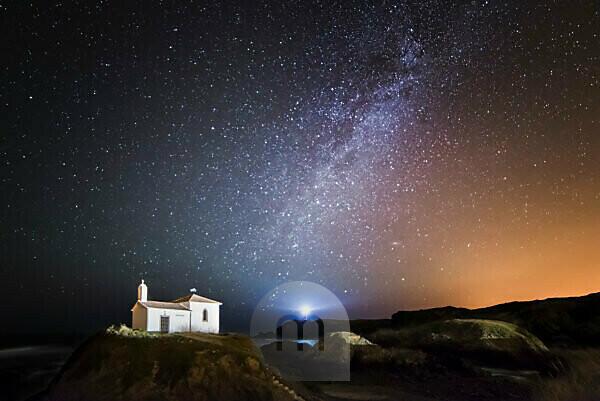 Bildagentur | mauritius images | Spain, Galicia, Valdovino, Little chapel  Virxe do Porto in the galician coast in a night shot with stars and milky  way