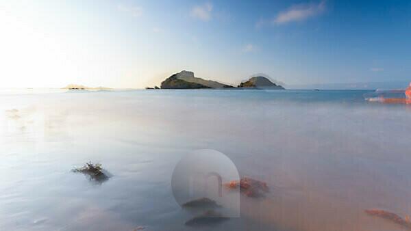 The sunset is reflected on the Beach of Masua, Iglesias