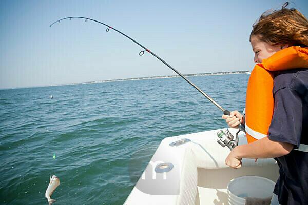 Boat woman legs puts up fishing rod detail people women-legs