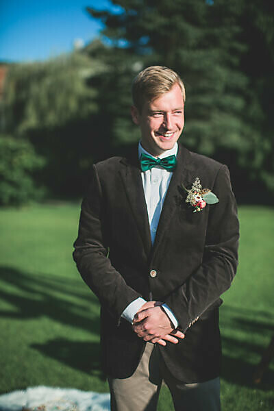 Bridegroom at wedding ceremony outside, half portrait
