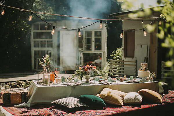 Festive laid table at alternative wedding celebration outside, detail