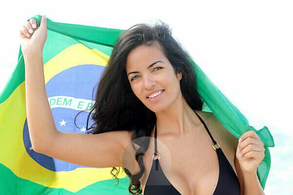 Illustrations of Beautiful Brazilian woman holding Brazil flag for