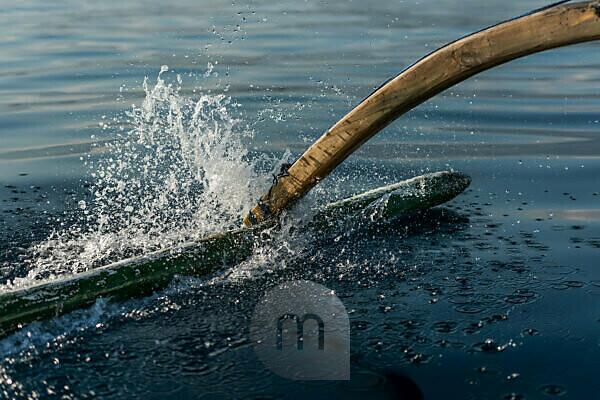 Man with Fly-fishing Pole Walking Through Shallow Water and