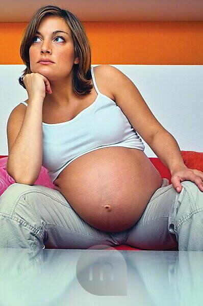 Woman with a Big Bare Tummy is Sitting on a Bed in Her Underwear with a  Bare Stomach. a Pregnant Lady and Her Husband Hold Their Stock Photo -  Image of contemplation