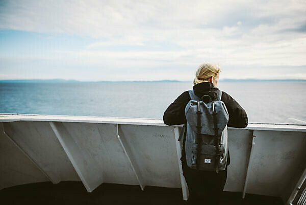 Woman on a ferry, looking into the distance, Vancouver Island, Canada