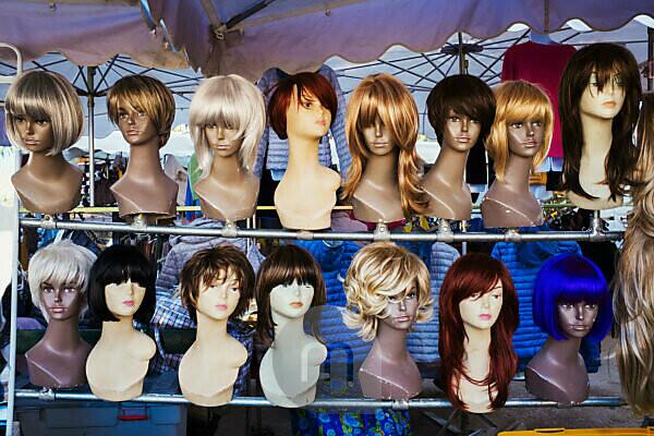 Pyramid shaped display of mannequin heads with wigs