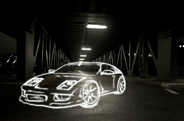 light drawing of a sports car on a bridge at night,