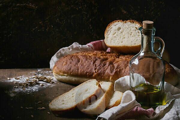 a loaf of fresh bread flour product in a bird's nest on a wooden