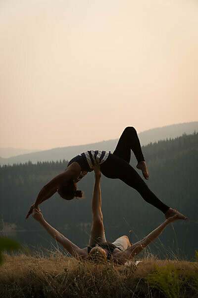 Acro Yoga, Three Sporty Girls Practice Yoga in Pair. Partner Yoga