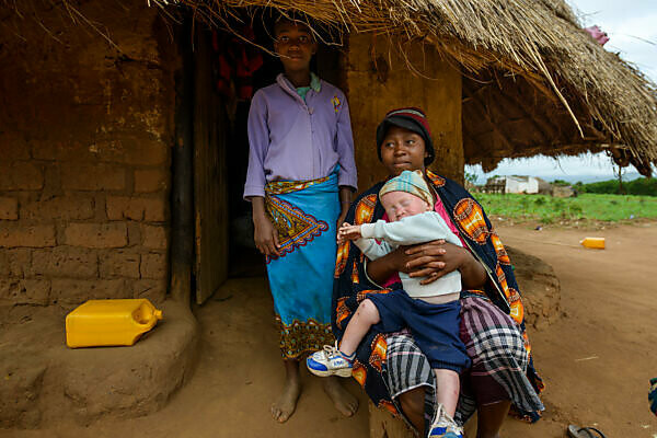 Bildagentur | mauritius images | Woman with albino boy sits in