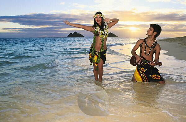 Rear view of two young women wearing bikinis on Lanikai Beach, Oahu,  Hawaii, USA stock photo