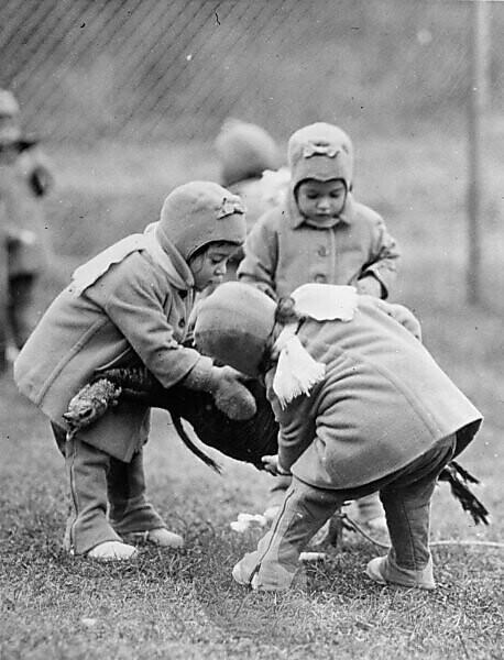 1930s 4 BOYS PULLING ON ROPE PLAYING TUG OF WAR ON PLAYGROUND ALL