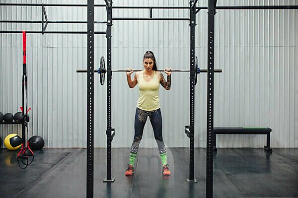 Closeup barbell with heavy weights on green grass on sports ground -  SuperStock