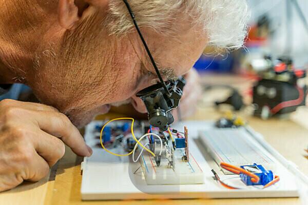 elderly grayhaired man pensioner examining counter with electronic