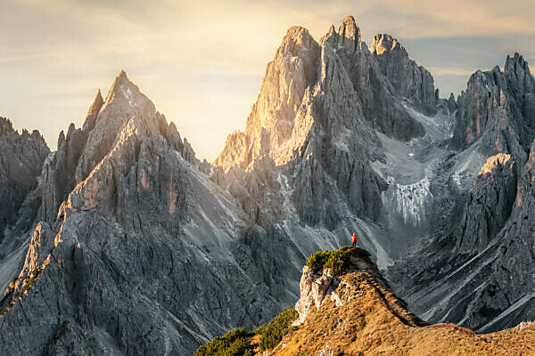 Hiker standing in front of the sharp peaks of Cadini di Misurina, Dolomites, Auronzo di Cadore, Belluno, Veneto, Italy