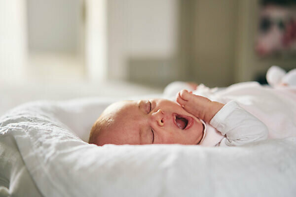 Baby sleeping on store u shaped pillow