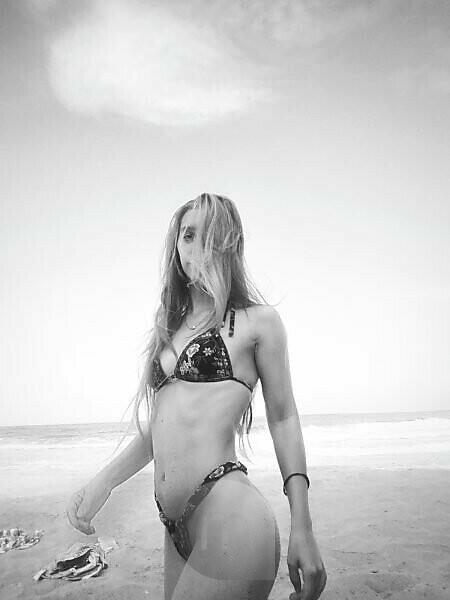 Portrait of sensuous young beauty in bikini at beach - SuperStock